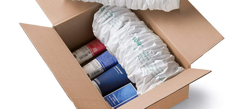
		  A cardboard box containing cosmetics and white paper cushioning