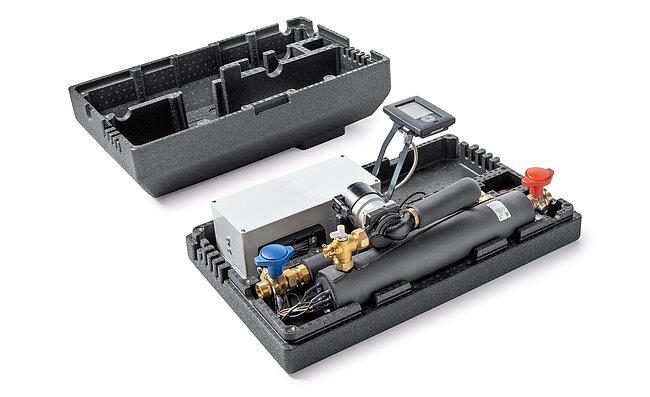 A man standing in front of a heating control panel